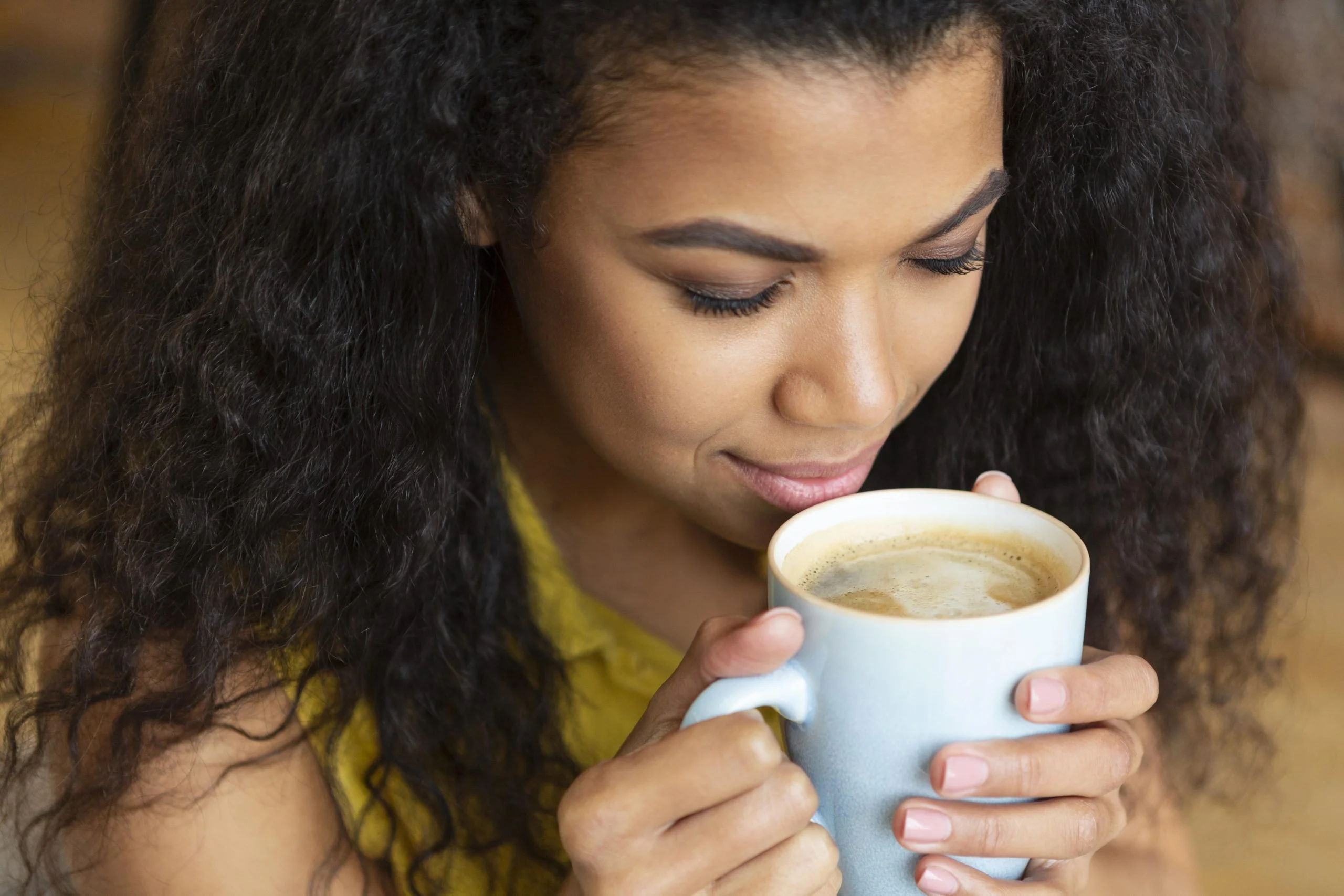 young-woman-enjoying-cup-coffee ontario canada Best colombian coffee